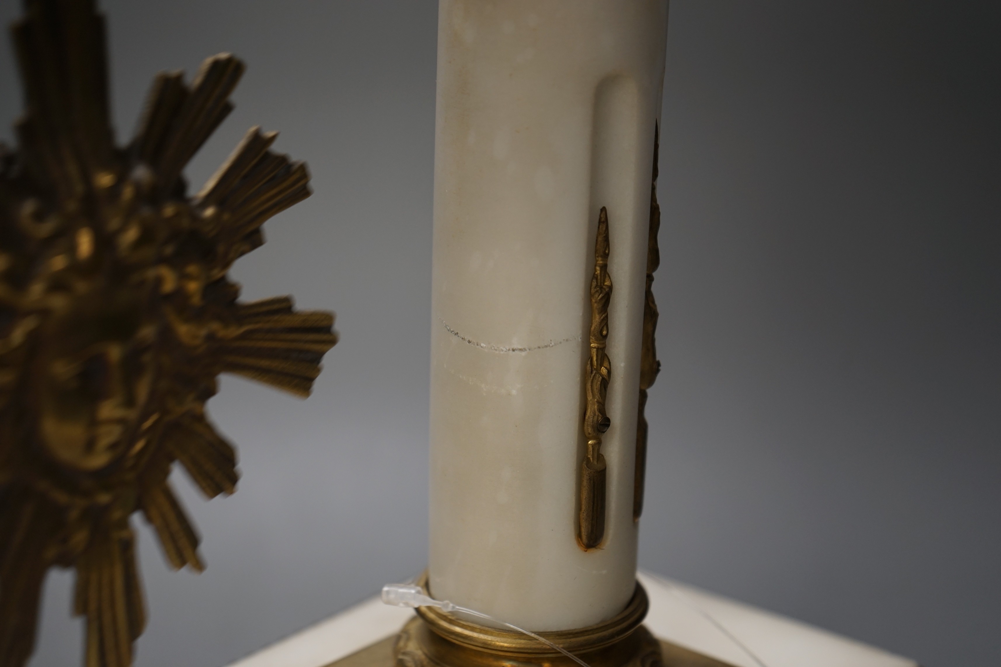 A large French white marble portico clock with ormolu decoration and sunburst pendulum, 59.5cm tall